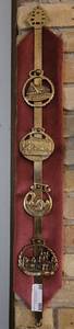 lot 20 image: LOT OF 4 VINTAGE HORSE HARNESS BRASS MEDALIONS WITH DISPLAY.