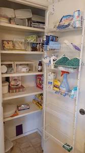 lot 150 image: CONTENTS OF PANTRY INCLUDING PLASTIC STORAGE CONTAINERS, PAPER GOODS, AND MORE.