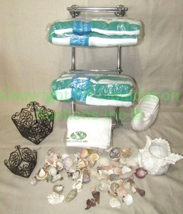 lot 101 image: New in package beach towels, towel rack, seashells, and decor as shown