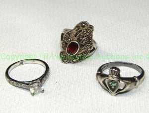 lot 111 image: Sterling Silver ring trio. Includes CZ solitaire (Marked 925 EC for European Union), marcasite with Garnet and a Celtic Claddagh ring