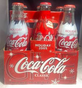 lot 59 image: 6pk Coca Cola Bottles Holiday 2005 and 1 Santa Coke Bottle