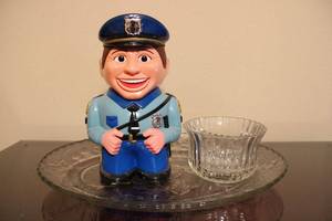 lot 19 image: Cookie Cop Talking Cookie Jar, Vintage FTDA 1986 Fluted Vase, Clear Crystal Platter with Fruit and Leaf Motif