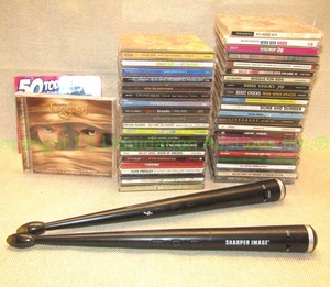 lot 16 image: Sharper Image digital drum sticks and assorted music CDs
