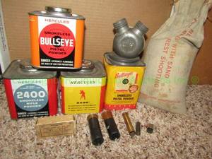 lot 87 image: Hercules smokeless gun powder (partially full), Winchester .218 caliber bullets, Lwarence chilled lead shot, and gun powder flask