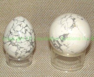 lot 216 image: Polished Howlite stone egg and ball on display stands, approx. 2 tall