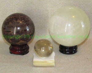 lot 225 image: Polished stone balls on pedestals including Volcanic Rhyolite, Quartz, and Yellow Calcite
