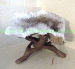 lot 272 image: Agate geode in wood display stand