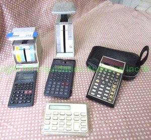 lot 212 image: Vintage Texas instruments, GIA and other brand calculators, plus Pelouze postal scales