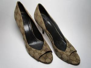 lot 25 image: Gucci monogrammed high heels, Size 8B, canvas material, UNIQUE HEEL, gently used, dust bag included