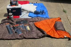lot 27 image: CAMPING LOT, 3 sleeping bags 1 has pillow, down comforter, new BBQ tools, Ice Chest, 2 large flashlights, pump, Miracle Thaw tray, Flask