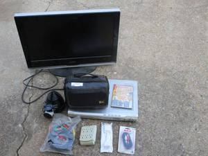 lot 37 image: 26 Vizio HDTV - POWERS ON, Sony portable DVD player with case and rotating screen -POWERS ON, mini projector, av cords, hdmi cable, dvd player