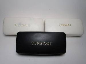 lot 47 image: 3 Versace Sunglasses cases, used, No sunglasses, some Versace lens cleaners and paperwork