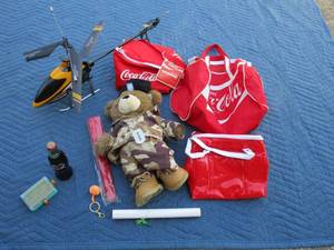 lot 70 image: Coca Cola bags, Electronic helicopter, 2003 full coke bottle, Army build-a-bear