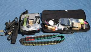 lot 102 image: Mossberg cases and a bunch of accessories, bandolier filled with roughly 56 12 gauge shells