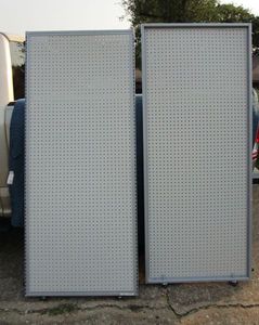 lot 129 image: Retail peg board w metal border and wheels