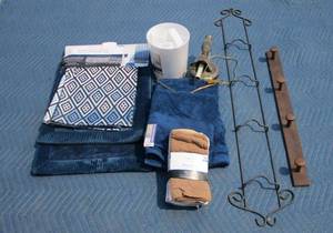 lot 136 image: Display rack, wooden hanging rack, New towels, bathmats and trashcan