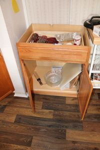 lot 19 image: Cabinet AND Contents of Cabinet Cutting Boards, Roll-up Drying Racks