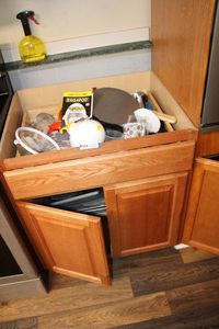 lot 24 image: Cabinet AND Contents of Cabinet Muffin Pans, Baking Pans, Egg Pod Egg Cooker, Food Chopper