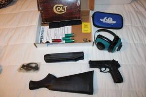 lot 72 image: Replacement Shotgun Stock, Gun Parts, Gamo PT-80 Pellet Pistol (appears broken), Shooting Earmuffs , Ammo 12Ga. Shells, .22 and 9 mm, Empty Colt Box for .38 Spec.