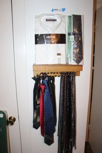 lot 91 image: Tie Rack, Generous Assortment of Ties including Clip Ties, Kirkland White Dress Shirt Unopened 16 x 33, and 2 Unopened Ties by Saddlebred