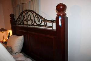 lot 103 image: Queen Size Wood and Metal Poster Bed Frame with Cherry Finish