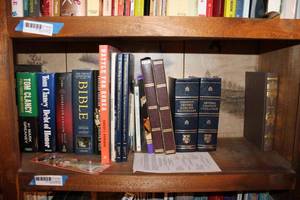 lot 155 image: Books on Shelf Dictionary, Tom Clancy Novels, Louis LAmour Novels and More