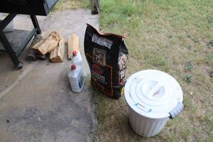 lot 215 image: Charcoal Briquets with Storage Bucket, Lighter Fluid, and Wood for SmokingGrilling