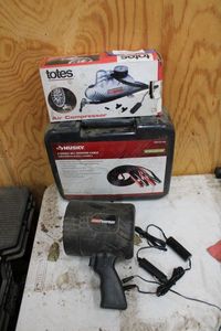 lot 277 image: Totes Air Compressor, Husky 4 Gauge 20 Ft. Booster Cable, Coleman Spot Light (may need new battery)