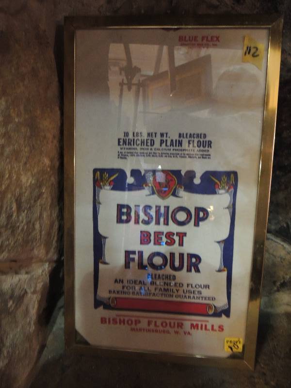 lot 112 image: BISHOP MILLS  Bishop Best Flour SACK   Frame 19.5x10.5
