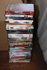 lot 64 image: DVDs Including Catching Fire, Hang Em High, Cloverfield, and Captain Ron