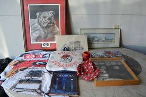 lot 100 image: Georgia Bulldogs Lot Books, Wall Art signed by Artists, Stadium Seat, Hat, and Bath Towel