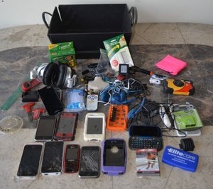lot 141 image: Used Cell Phones, Headphones, Mighty Putty, and Hockey Collectors Cards