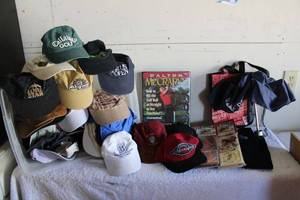 lot 134 image: Golf Lot US Open, Ball Caps (lots of tournament caps), Dalton McCrarys Golf Lessons Video Set, Pub World Towel and Coaster Sets