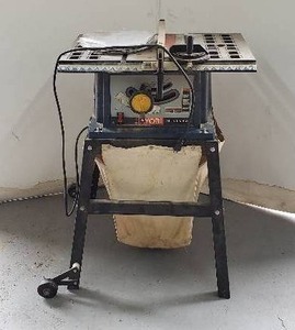 lot 65 image: Ryobi BTS10S 10 Table Saw with Stand, Dust Collector, and 6 Extra Blades