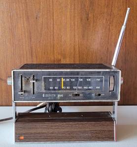 lot 31 image: VINTAGE 1970S ZENITH RADIO CORP. RB57Y PORTABLE TRANSISTOR AMFM RADIO WITH STANDADAPTER AS SHOWN. TESTED AND WORKING.