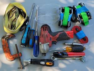 lot 72 image: MIXED TOOL LOT INCLUDING STRAPS, C-CLAMP, SCREWDRIVERS, GOGGLES, AND MORE AS SHOWN.
