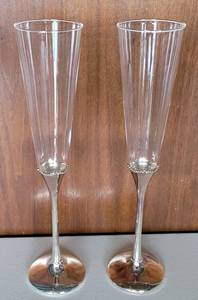 lot 111 image: WATERFORD CRYSTAL TOASTING FLUTES WITH SILVER PLATE BASES. MARKED WATERFORD ON BOTTOM (PAIR) AS SHOWN.