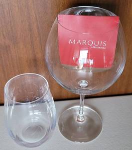 lot 112 image: MARQUIS BY WATERFORD CRYSTAL RED WINE GLASS 9H (marked) and stemless wine glass (marked) 5H AS SHOWN.