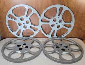 lot 233 image: LOT OF 4 VINTAGE METAL MOVIE REELS AS SHOWN. EACH APPROX. 12 DIAMETER. (SOLD 4X THE MONEY)