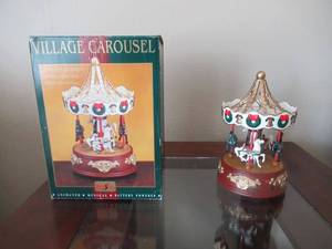 lot 30 image: 2 CHRISTMAS VILLAGE CAROUSELS ANITMATED AND MUSICAL ONE IN BOX ONE WITHOUT BOX