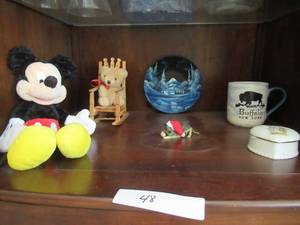 lot 48 image: MICKEY MOUSE STUFFED ANIMAL, SMALL BEAR IN ROCKING CHAIR, PAINTED TIN PLATE, BUFFALO NY CUP, CERAMIC KEEPSAKE AND CERAMIC MINI GERMAN SHEPHERD WITH CHRISTMAS HAT