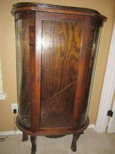 lot 59 image: VINTAGE SOLID OAK DISPLAY CASE 37 X 14 X 56 GLASS IS CRACKED ON ONE SIDE AND LEG NEEDS ATTENTION VERY SALVAGEABLE