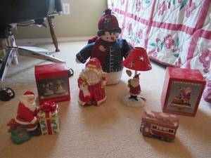 lot 64 image: CHRISTMAS GOODIES INCLUDING FROSTY SNOWMAN, SANTA LAMP, CERAMIC SANTA, CERAMIC HOLIDAY TRAIN, 2 POLYRESIN STOCKING HOLDERS IN BOXES AND PLASTIC SANTA CLAUS