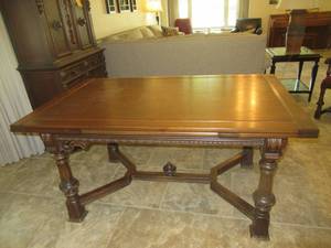 lot 18 image: VINTAGE OAK ART DECO DINING TABLE WITH BUILT IN LEAVES 52 X 38 X 31 WITH LEAVES OUT 96. ALL RECORDS KEPT AND ALL MATCHING LOTS WERE IMPORTED FROM SPAIN IN THE 1930S. MATCHES LOTS 19, 20 AND 21.