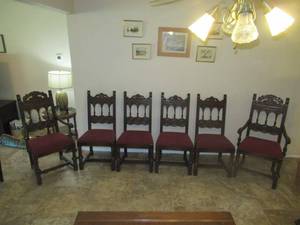 lot 19 image: VINTAGE OAK ART DECOR DINING CHAIRS WITH ORNATE DESIGN 19 TO SEAT 42 TO TOP OF CHAIR BACK. THESE MATCH LOTS 18, 20 AND 21. 2 CHAIRS WITH ARMS 4 WITHOUT ARMS. FOR THE  AGE IN GOOD CONDTION CHAIRS WERE RECOVERED IN 1997.