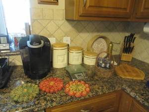 lot 41 image: KEURIG SINGLE COFFEE CUP MAKER, MIRACLE BLADE KNIFE AND CUTTING BOARD SET, 3 PIECE COFFEE, TEA, AND SUGAR CANISTER SET, CRUISINART KITCHEN DIGITAL SCALE, SILVERPLATE PEPPER GRINGER AND HOT PLATES