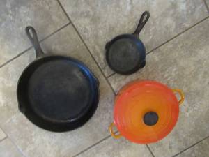 lot 44 image: 12 78 CAST IRON SKILLET MARKED NO. 10, GRISWOLD 8 CAST IRON SKILLET MARKED NO.3 AND ORANGE LE CREUSET DUTCH OVEN 2.7 QUART