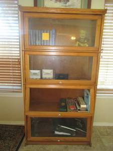lot 69 image: SOLID OAK 4 TIER DISPLAY CABINET 36 X 15 X 68. THIRD SECTION OF GLASS NEEDS REPLACING BUT BEAUTIFUL PIECE