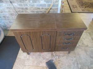 lot 83 image: BERNINA RECORD SEWING MACHINE BUILT INTO TABLE WITH FOOT PEDAL AND ALL THE SEWING ACCESSORIES . CABINET MEASURES 39 X 16 X 30 12