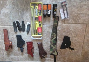 lot 151 image: OUTERS GUN CLEANING KIT, BORE GEL, GUN OIL, LUBRICANT, GUN STOCK ENDS, RUGER GUN LOCK WITH KEY, AND 3 LEATHER PISTOL HOLDERS AND 3 NYLON PISTOL HOLDERS